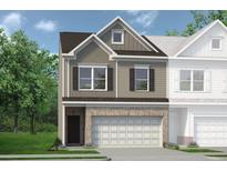 Two-story townhome with neutral siding, brick accents, and a two-car garage at 2620 Ravencliff Dr # 163, Austell, GA 30168
