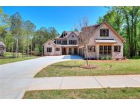 Beautiful brick home with a well-manicured lawn and long driveway leading to a three car garage at 43 Iroquois Ct, Covington, GA 30014
