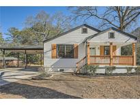 Charming renovated home with white siding, a covered porch, and a landscaped yard at 5603 Owens Dr, Austell, GA 30106