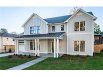 Stunning two-story farmhouse with a metal roof and charming front porch at 89 1St Ne Ave, Atlanta, GA 30317