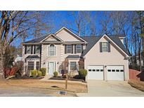 Two-story house with a two-car garage and well-manicured lawn at 6108 Waterton Dr, Lithonia, GA 30058