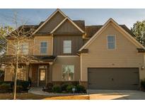 Two-story house with brick and beige siding, attached garage, and landscaping at 2496 Osceola Rd, Lithonia, GA 30058