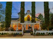 Evening view of charming two-story home with white picket fence at 3532 South Fulton Ave, Hapeville, GA 30354