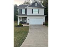 Charming two-story home features a two-car garage, covered porch, and well-maintained landscaping at 130 Bingley Ct, Covington, GA 30016
