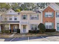 Inviting townhome featuring a charming facade and well-maintained landscaping at 2320 Whitestone Pl, Alpharetta, GA 30005