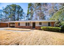 Brick ranch house with carport and landscaped yard at 2283 Country Club Sw Ln, Atlanta, GA 30311