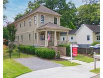 Charming two-story home features a welcoming front porch, lush landscaping, and a 'Coming Soon' sign at 301 Fortune Ne St, Atlanta, GA 30312