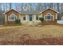 Ranch home with stone accents and a landscaped yard at 332 Stonecutters Cv, Stockbridge, GA 30281