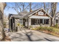 Charming craftsman-style home featuring a cozy front porch, gray brick, and inviting curb appeal at 1316 North Ne Ave, Atlanta, GA 30307