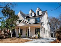 Two-story farmhouse features a front porch, and a neutral color scheme at 17 Rockyford Ne Rd, Atlanta, GA 30317