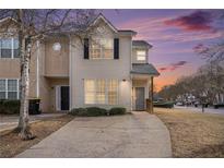 Two-story townhome with a charming front porch and driveway at 2326 Nicole Dr, Hampton, GA 30228