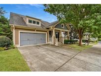 Charming home with two-car garage, covered porch, and well-manicured landscaping at 101 Chestnut Dr, Canton, GA 30114