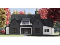 Two-story farmhouse with black and white exterior, and a pitched roof at 115 Palisade Dr, Rydal, GA 30171