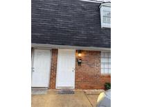 Brick townhouse with white doors and dark gray roof at 3882 Parklane Dr, Clarkston, GA 30021