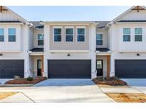 Two-story townhome with attached garage and landscaping at 5535 Rockfern Dr, Lilburn, GA 30047
