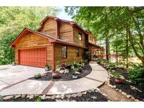 Two story home with wood siding, red door and walkway at 4955 H D Atha Rd, Covington, GA 30014