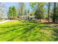 Ranch style home with landscaped yard and large windows at 3613 Embry Cir, Chamblee, GA 30341