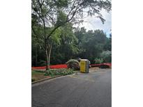 Construction site with portable toilet and heavy equipment surrounded by orange safety fencing and trees at 3910 W Cooper Lake Se Dr, Smyrna, GA 30082
