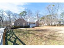 Brick ranch house with large yard and wrap-around porch at 4801 Daniel Mill Rd, Winston, GA 30187