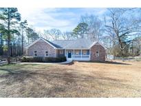 Charming single-story brick home with a welcoming front porch and well-maintained lawn at 4801 Daniel Mill Rd, Winston, GA 30187