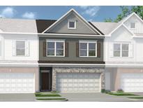 Two-story townhome with gray siding, stone accents, and a two-car garage at 2580 Ravencliff Dr # 159, Austell, GA 30168
