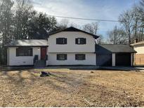 Charming two-story home with white painted brick and a well-maintained front yard at 2715 Heritage Ln, Morrow, GA 30260