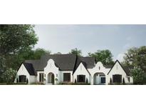 Stunning white two-story home with black roof, arched entryways, and landscaping at 11 Nathan Cir, Alpharetta, GA 30009