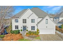 Stunning two-story home with white exterior, landscaping, and a three-car garage at 110 Crestwicke Trce, Atlanta, GA 30319