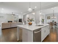 Bright open-concept kitchen featuring a large island, stainless steel appliances, and hardwood floors at 6320 Halcyon Garden Dr, Alpharetta, GA 30005