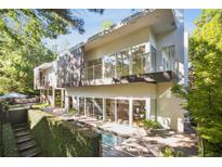 Modern two-story home with a pool and landscaped grounds at 9044 Selborne Ln, Chattahoochee Hills, GA 30268