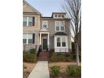 Two-story townhome with brick and siding exterior, front porch, and landscaping at 1284 Park Bench Pl, Mableton, GA 30126