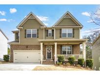 Two-story house with brick and siding, a large yard, and a two-car garage at 1567 Brunswick St, Lithia Springs, GA 30122