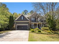 Charming two-story home with a well-manicured lawn, two car garage and inviting front porch at 120 Fountain Oak, Villa Rica, GA 30180