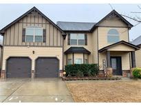 Charming two-story home with a two-car garage and a welcoming front porch at 1370 Long Acre Dr, Loganville, GA 30052