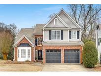 Two-story brick and siding home with a two-car garage and manicured lawn at 44 Whitlock Sw Sq, Marietta, GA 30064