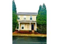 Two-story house with a traditional design, featuring a brick facade and landscaping at 3236 Tallon Sw Ln, Atlanta, GA 30311