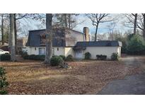 Ranch style home with a unique roofline, mature trees, and a spacious yard at 1221 Kenyon Rd, Lake City, GA 30260