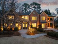 Stunning brick home with stone accents, welcoming front porch, and mature landscaping at 4835 Merlendale Ct, Atlanta, GA 30327