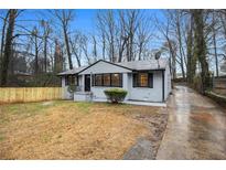 Charming painted brick home with fresh landscaping and a long driveway at 2313 Springdale Sw Rd, Atlanta, GA 30315