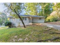 Charming ranch home with a well-maintained lawn and driveway at 3235 Mcafee Rd, Decatur, GA 30032