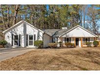 Newly renovated house exterior with a white wood siding and a covered porch at 8852 Elon Trl, Jonesboro, GA 30238