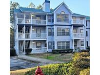 Two-story building with light blue siding, balconies, and landscaping at 3526 Shepherds Path # 1, Decatur, GA 30034