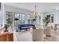 Bright living room features a comfy blue sofa and stylish armchairs, perfect for relaxation at 775 Juniper Ne St # 327, Atlanta, GA 30308