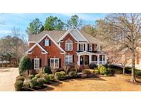 Charming brick two-story home featuring a well-manicured lawn and a welcoming front porch at 1117 Blackwell Farm Ne Dr, Marietta, GA 30068