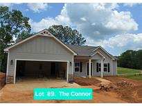 Charming single-story home with gray siding, stone accents, and an attached two-car garage in a residential area at 8970 Callaway Dr, Winston, GA 30187