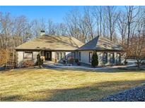 Stunning ranch home with inviting front porch and manicured lawn at 201 Windflower Ct, Canton, GA 30115