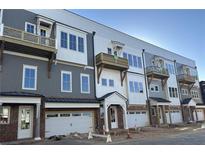 New townhome exteriors with garages, balconies and craftsman details create a warm and welcoming neighborhood at 4213 Legacy Ln # 32, Acworth, GA 30101