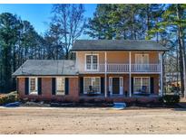 Charming two-story brick home with a welcoming front porch and balcony at 1357 Ridgewood Dr, Lilburn, GA 30047