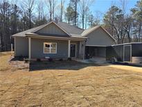 Charming single-story home with a two-car garage, manicured lawn, and mature trees at 8971 Callaway Dr, Winston, GA 30187