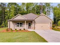 Charming one-story home with a two-car garage, nicely landscaped front yard, and craftsman-style details at 8971 Callaway Dr, Winston, GA 30187